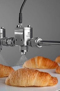 BETE HydroPulse EHP Hygienic Automatic Spray Nozzles Spraying Croissants